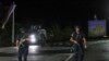 Sejumlah petugas kepolisian berjaga di sebuah jalan dekat Desa Banjska, utara Kosovo, setelah 30 pria bersenjata menembak mati seorang polisi Kosovo Albania dan menyerbu sebuah biara Kristen Ortodoks, Minggu, 24 September 2023. (Foto: Bojan Slavkovic/AP Photo)
