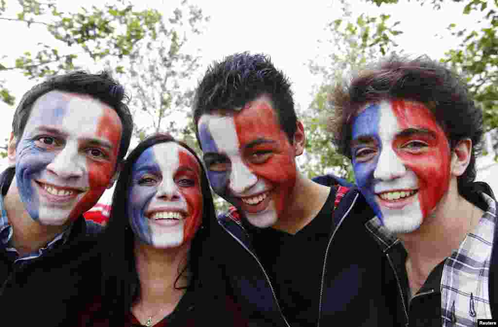 Fans of France's handball team pose for photos before their men's handball Preliminaries Group A match against Britain at the Copper Box venue during the London 2012 Olympic Games July 29, 2012.