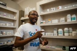 FILE: Luckymore Bhunu, secretary for the Retail Pharmacists Association, speaks with an AFP journalist in Harare on October 9, 2018, about drug shortage in Zimbabwe as many essential drugs, including those for diabetics and hypertensive patients, are in short supply.