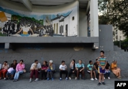 People wait in the streets after evacuating buildings in Caracas, Aug. 21, 2018, following a 7.3-magnitude earthquake that struck in Venezuelan northeastern state of Sucre according to the U.S. Geological Survey.