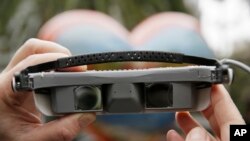 ESight CEO and President Brian Mech holds up a pair electronic glasses at Union Square San Francisco, Feb. 2, 2017. The glasses enable the legally blind to see.