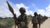 FILE - African Union Mission in Somalia (AMISOM) peacekeepers from Burundi patrol after fighting between insurgents and government soldiers erupted on the outskirts of Mogadishu.