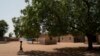 FILE - A girl carries a bucket of water from a community well in the village of Ndiawagne Fall in Kebemer, Senegal, Nov. 5, 2021. The region is on one end of a project called the Great Green Wall that was once envisioned as a way for Africa to fight clima
