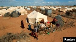 FILE - Refugees stand outside their tent at the Ifo Extension refugee camp in Dadaab, near the Kenya-Somalia border, Oct. 19, 2011. Ahmed Warsame, the new UNHCR director for global emergencies has led UNHCR operations in Dadaab.