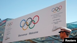 A Monaco policeman stands in front of the Grimaldi Forum during the opening of the 127th International Olympic Committee (IOC) session in Monaco, Dec. 8, 2014. 