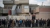 Iraqi civilians line up to receive food supplies in a neighborhood recently liberated by Iraqi security forces in western Mosul, March 14, 2017. 