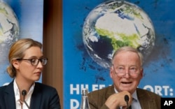 Alice Weidel, left, and Alexander Gauland, right, top candidates of the German AfD (Alternative for Germany) party for the upcoming general elections, attend a press conference in Berlin, Germany, Monday, Aug. 21, 2017.