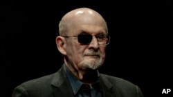 FILE - Salman Rushdie poses for a portrait to promote his book 'Knife: Meditations After an Attempted Murder' at the Deutsches Theater in Berlin, May 16, 2024. 