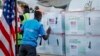 FILE - A UNICEF worker checks boxes of the Moderna coronavirus vaccine, donated by the U.S. government via the COVAX facility, after their arrival at the airport in Nairobi, Kenya, Aug. 23, 2021. 