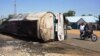A motorcycle rides past what remains of a fuel tanker whose explosion killed more than 140 people in Majiya, Nigeria, on Oct. 16, 2024.