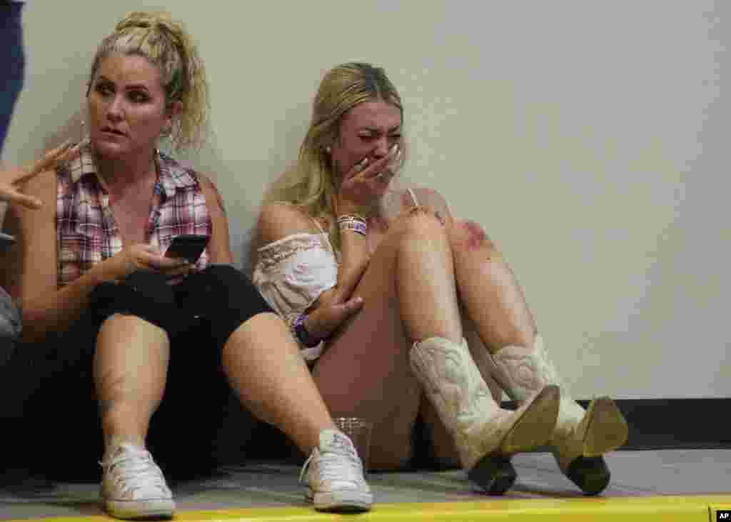 A woman cries while hiding inside the Sands Corporation plane hangar after a mass shooting in which dozens were killed at the Route 91 Harvest country festival on Oct. 1, 2017, in Las Vegas.