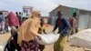 FILE - Food supplies are distributed during a visit by WFP Regional Director to a camp for the IDP in Adadle, Ethiopia, Jan. 22, 2022. 