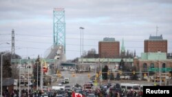 Pengemudi truk dan pendukung memblokir akses ke Jembatan Ambassador, yang menghubungkan Detroit dan Windsor, sebagai protes terhadap mandat vaksin COVID-19, di Windsor, Ontario, Kanada 12 Februari 2022. (Foto: REUTERS/Carlos Osorio)