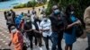 FILE - People wait to register for the first injection of the Oxford/AstraZeneca COVID-19 vaccine during the launch of a vaccination campaign, at the Kenyatta International Convention Centre in Nairobi, Kenya, April 21, 2021.