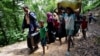 Rohingya people walk toward the makeshift shelter near the Bangladesh-Myanmar border in Cox’s Bazar, Bangladesh, Aug. 28, 2017.