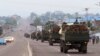 FILE - Military trucks carrying Congolese troops drive down a main street after violence erupted due to the delay of presidential elections, in Kinshasa, Democratic Republic of Congo, Sept. 20, 2016.