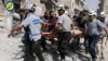 Sept. 21, 2016, file photo, provided by the Syrian Civil Defense White Helmets, rescue workers work the site of airstrikes in the al-Sakhour neighborhood of the rebel-held part of eastern Aleppo, Syria.