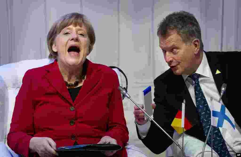 German Chancellor Angela Merkel, laughs talking to Finland's President Sauli Niinisto as they attend an informal plenary session on the last day of the Nuclear Security Summit (NSS) in The Hague, Netherlands.