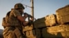 FILE - A Ukrainian government soldier fires toward Russia-backed rebel positions near Avdiivka, outside Donetsk, eastern Ukraine, Aug. 23, 2015.